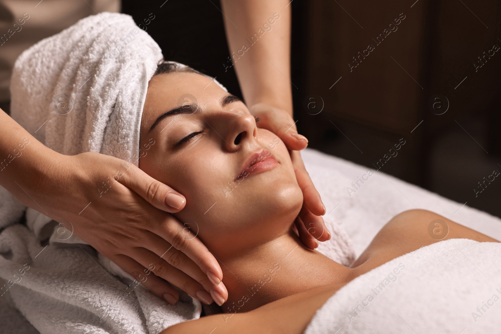 Photo of Attractive woman enjoying face massage, closeup. Beauty procedure