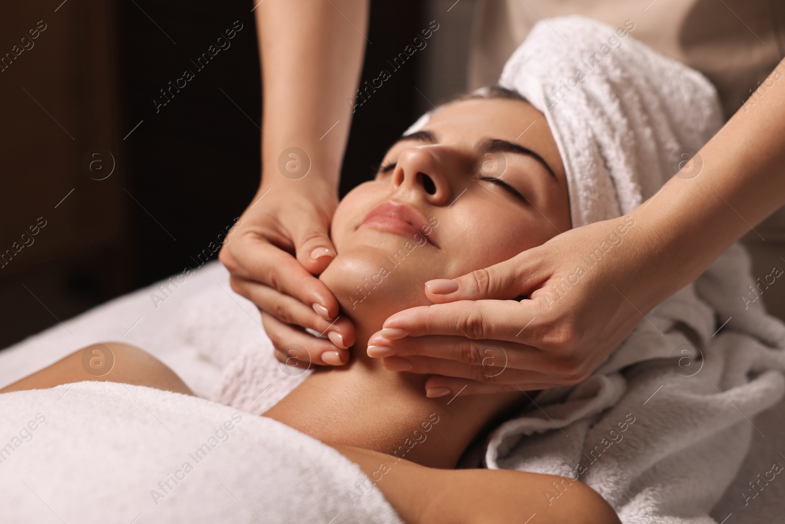 Photo of Attractive woman enjoying face massage, closeup. Beauty procedure