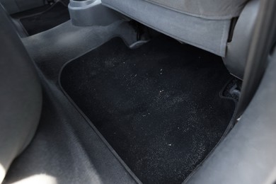 Photo of Black soft car floor mat in auto