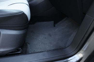 Photo of Grey rubber car floor mat in auto