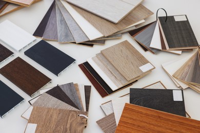 Photo of Different samples of wooden flooring on white table