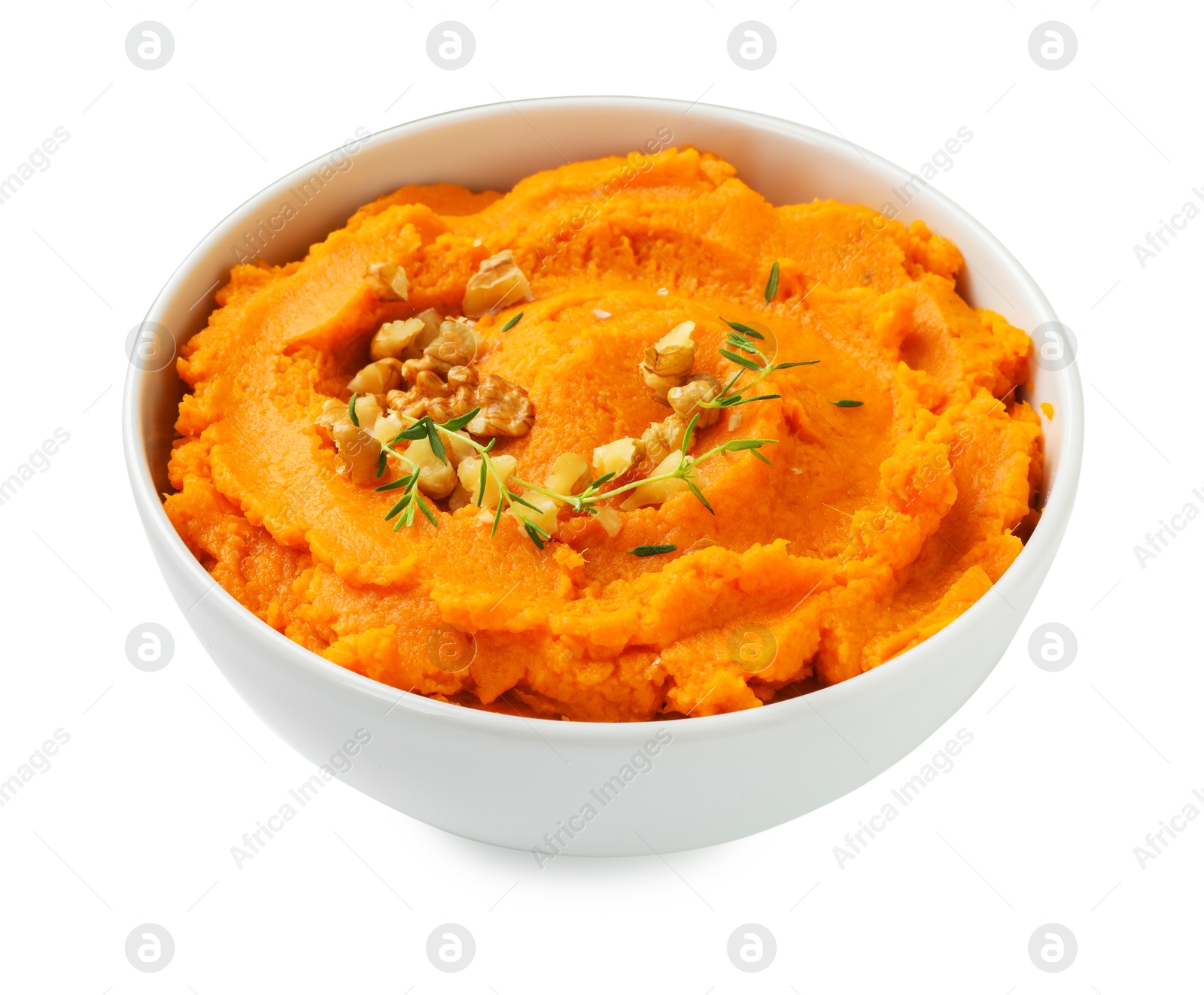 Photo of Delicious mashed sweet potatoes and walnuts in bowl isolated on white