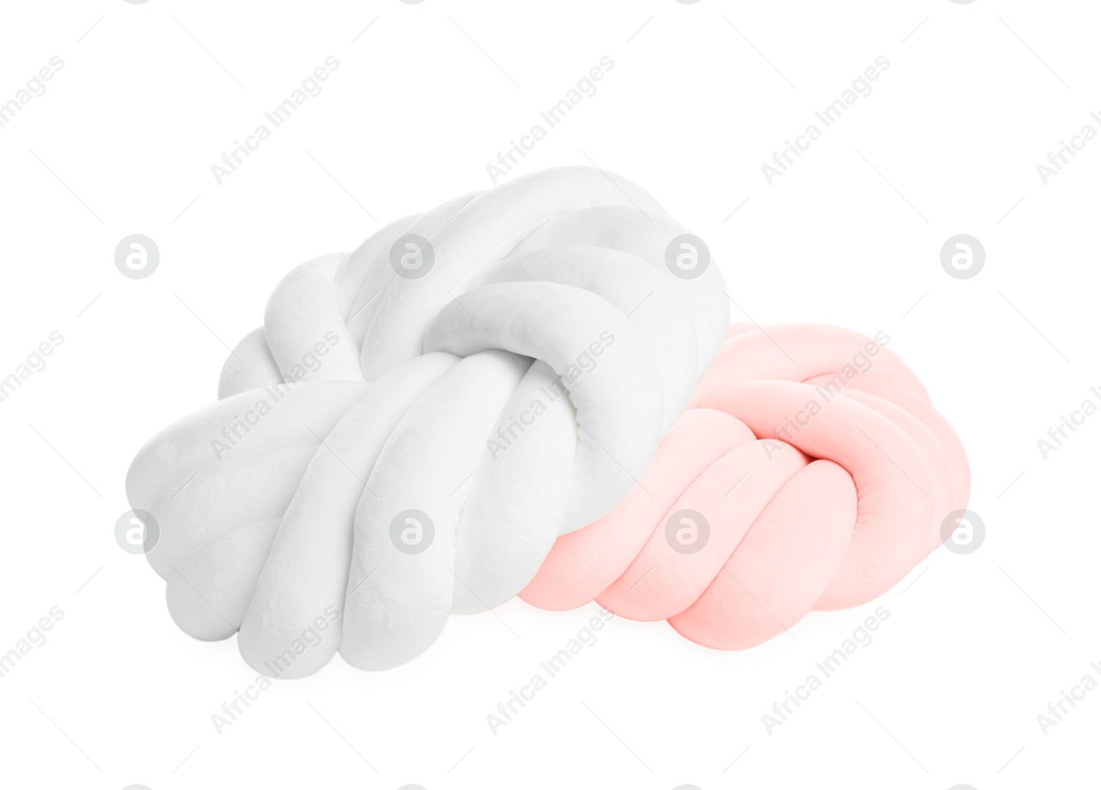 Photo of Two soft color pillows in shape of knots isolated on white