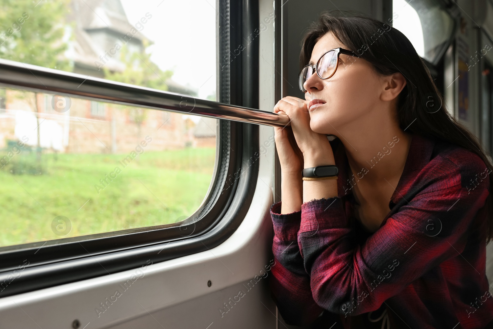 Photo of Beautiful woman looking out of train window during trip