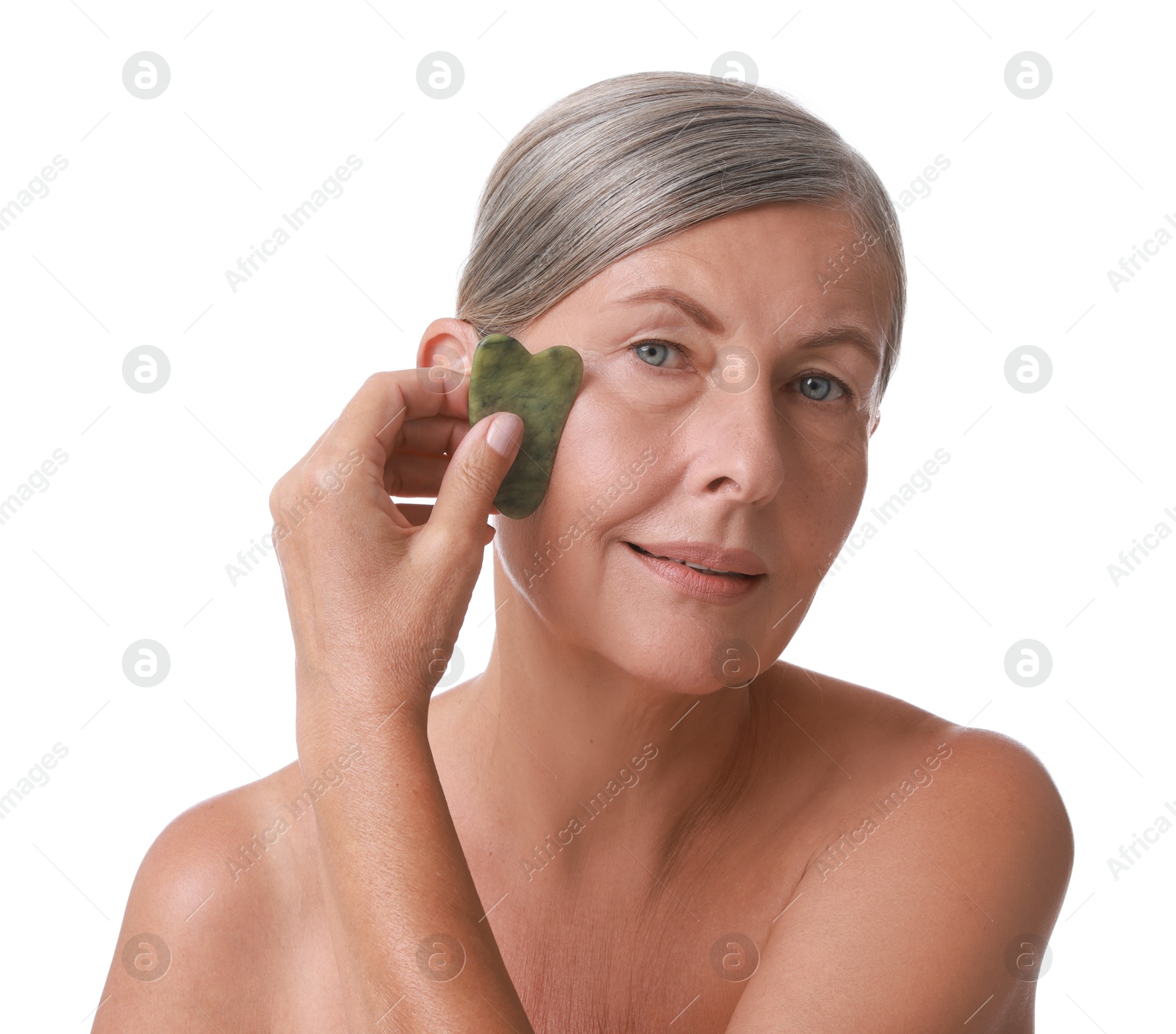 Photo of Beautiful woman doing facial massage with gua sha tool on white background