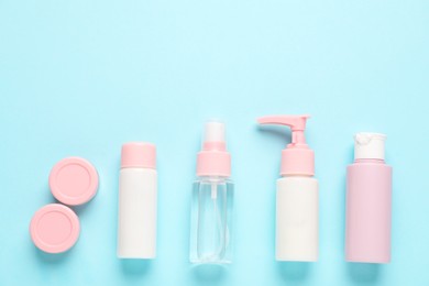 Photo of Different cosmetic products on light blue background, flat lay