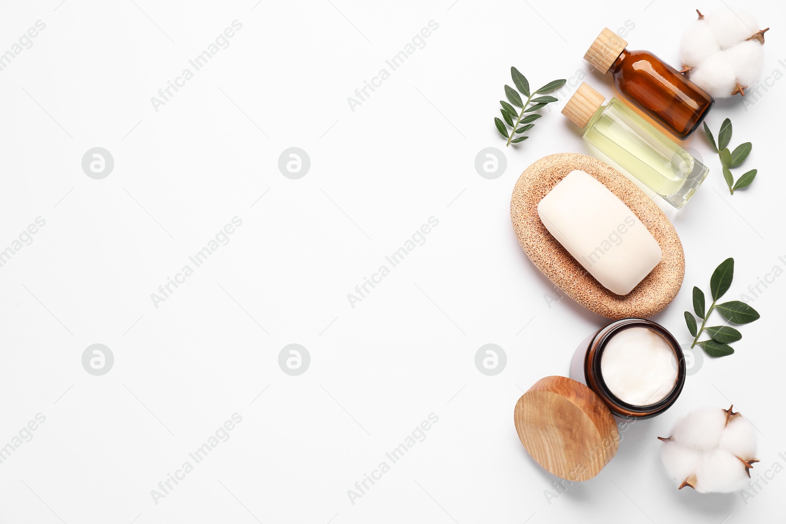 Photo of Different cosmetic products, cotton flowers and leaves on white background, flat lay. Space for text