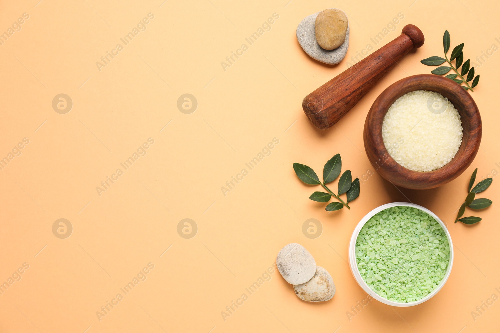 Photo of Different cosmetic products and green leaves on pale orange background, flat lay. Space for text