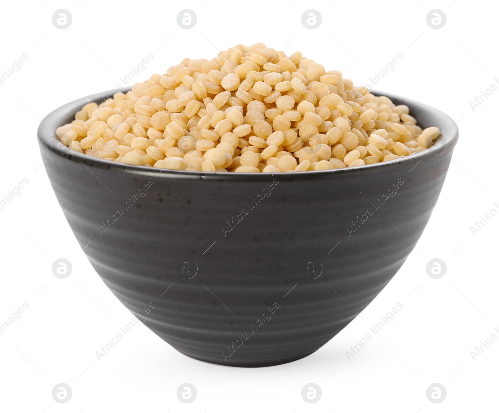 Photo of Raw couscous in bowl isolated on white