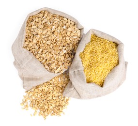 Different cereal grains in burlap sacks isolated on white, top view