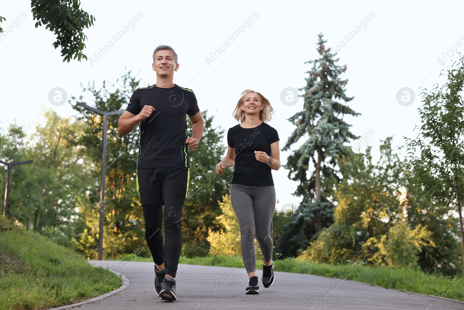 Photo of Happy couple running in park. Healthy lifestyle