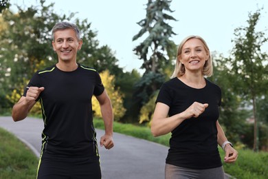 Photo of Happy couple running in park. Healthy lifestyle