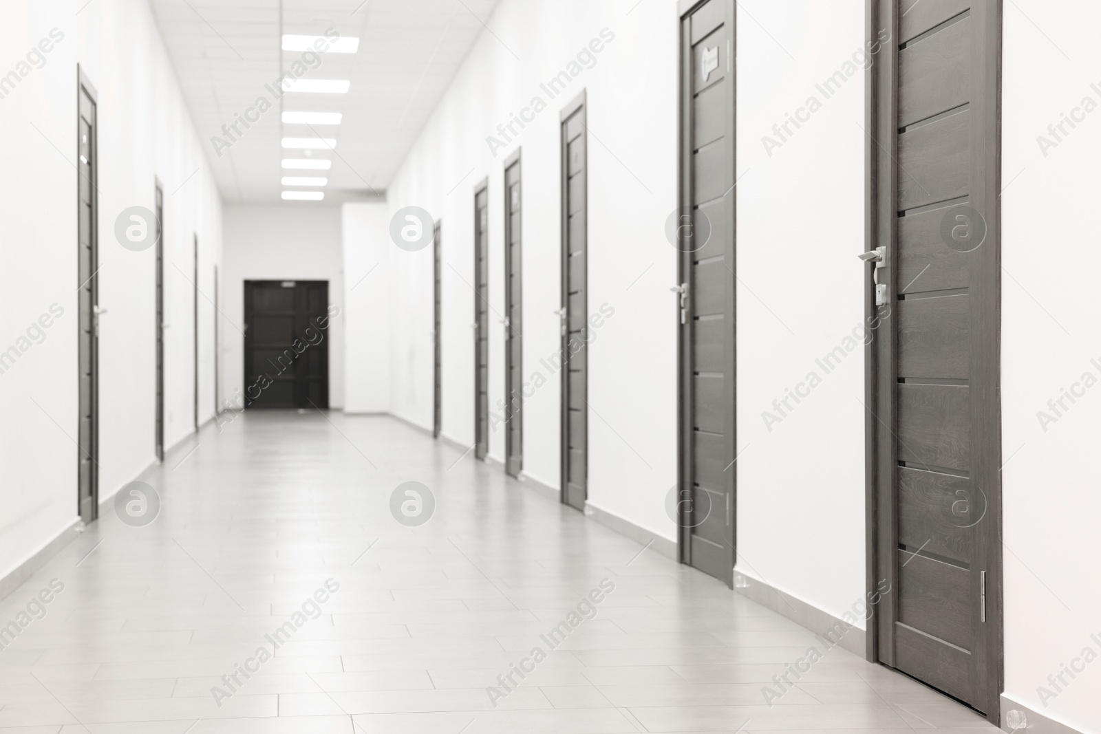 Photo of View of empty hospital corridor with wooden doors