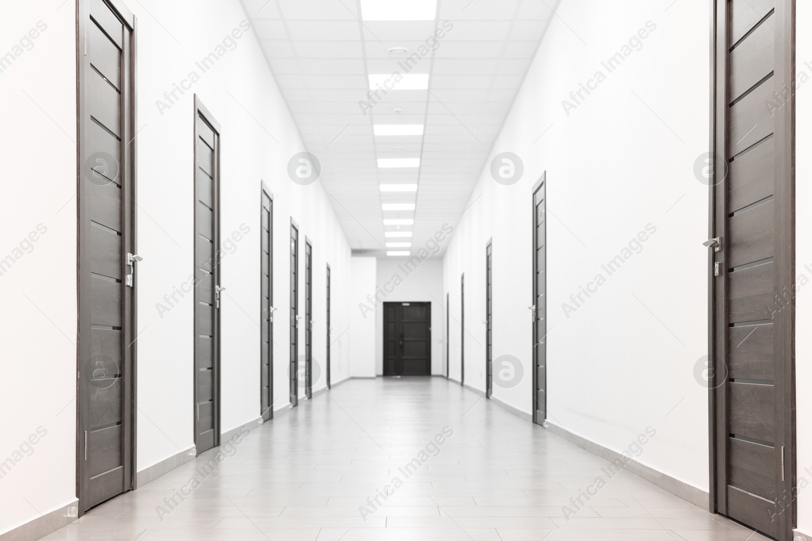 Photo of View of empty hospital corridor with wooden doors