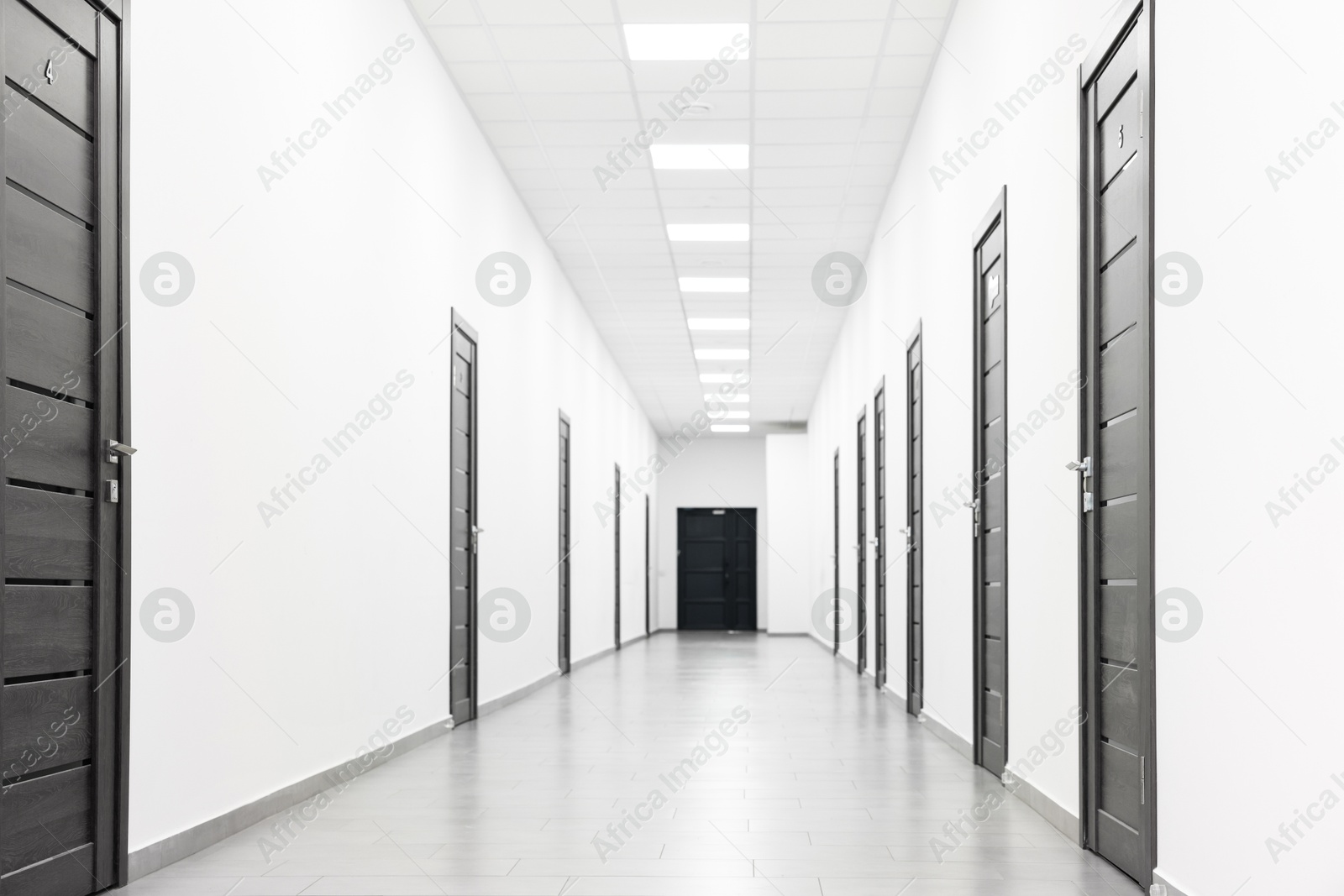 Photo of View of empty hospital corridor with wooden doors