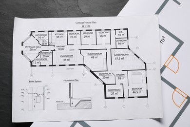 Photo of Different engineering drawings on grey textured table, flat lay