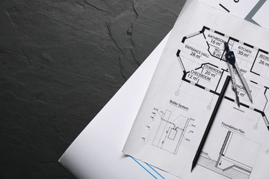 Photo of Different engineering drawings, pencil and divider on grey textured table, flat lay. Space for text