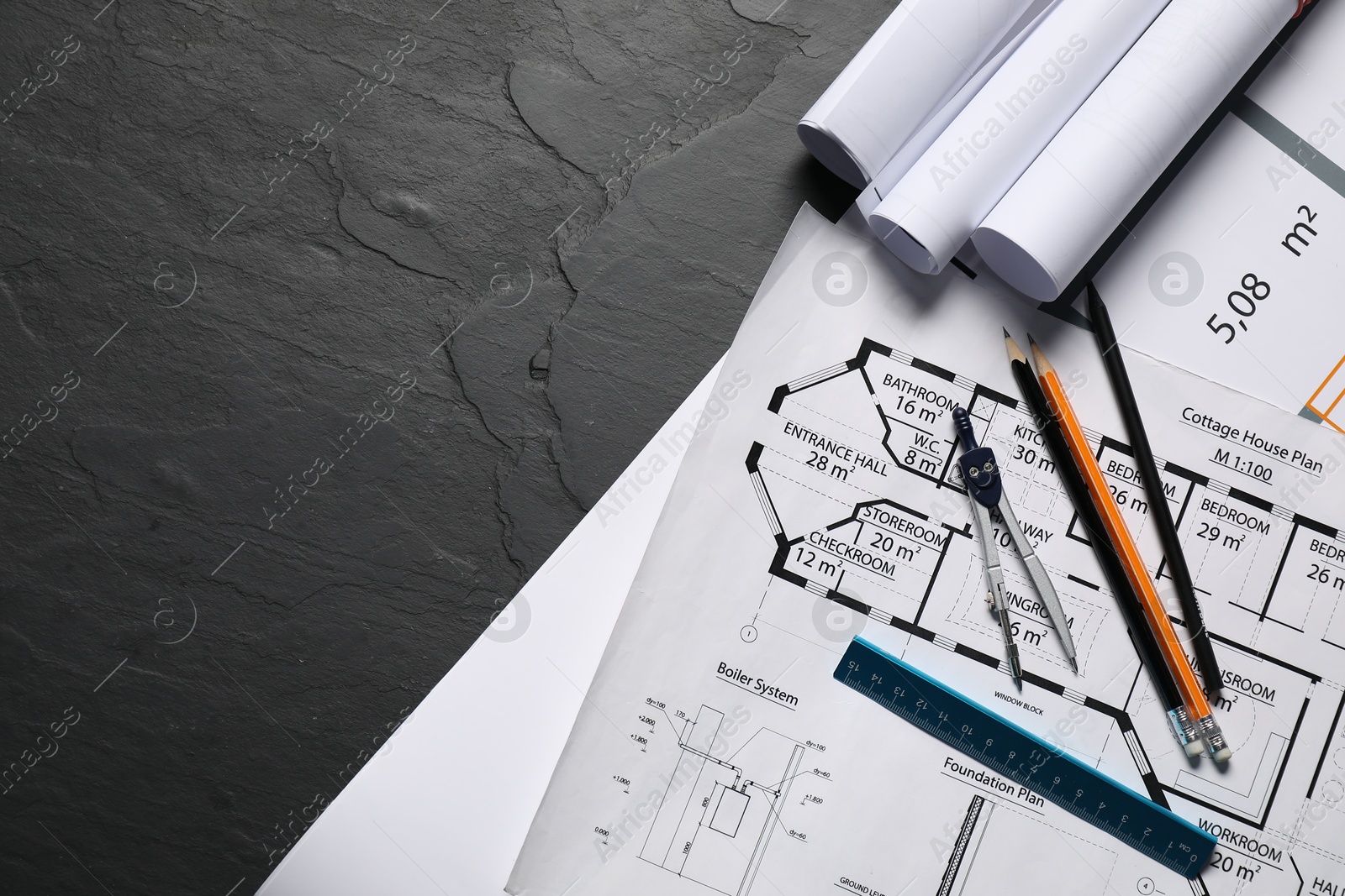 Photo of Different engineering drawings and tools on grey textured table, flat lay. Space for text