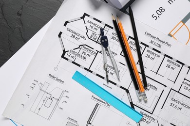 Photo of Different engineering drawings and tools on grey textured table, flat lay