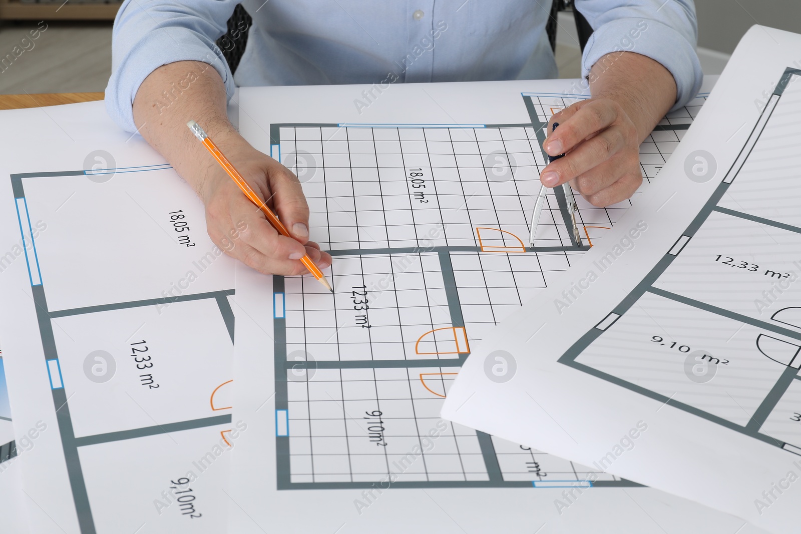 Photo of Architect working with project at table in office, closeup