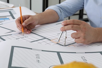 Photo of Architect working with project at table in office, closeup