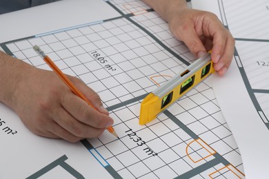 Photo of Architect working with project at table in office, closeup