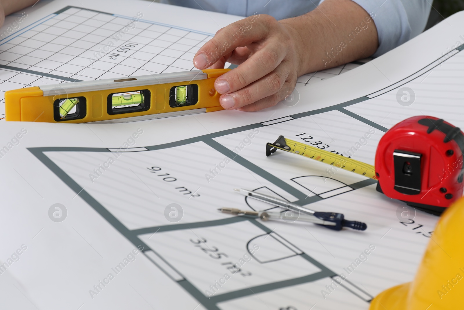 Photo of Architect working with project at table in office, closeup