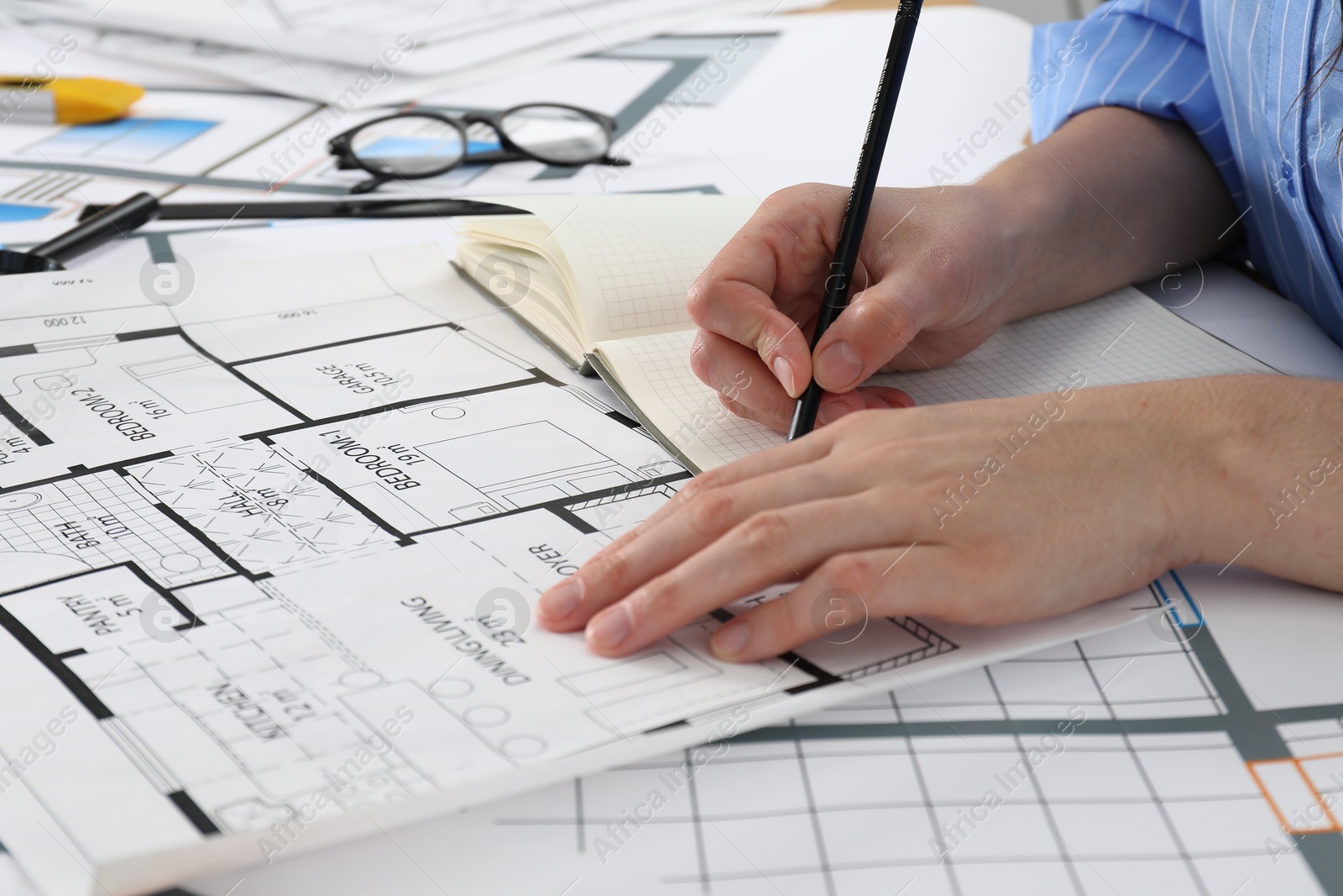 Photo of Architect working with project at table in office, closeup