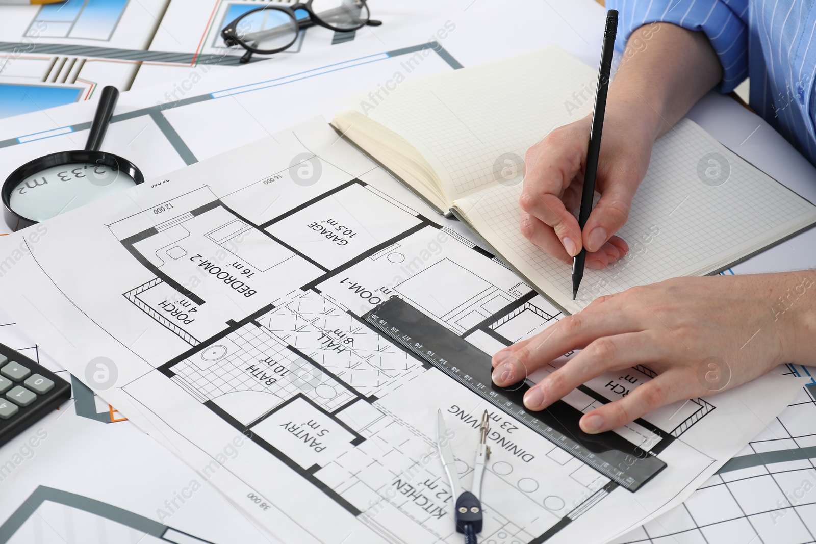 Photo of Architect working with project at table in office, closeup