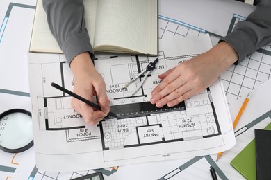 Architect working with project at table in office, top view