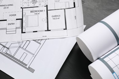 Different architectural drawings on grey textured table, flat lay