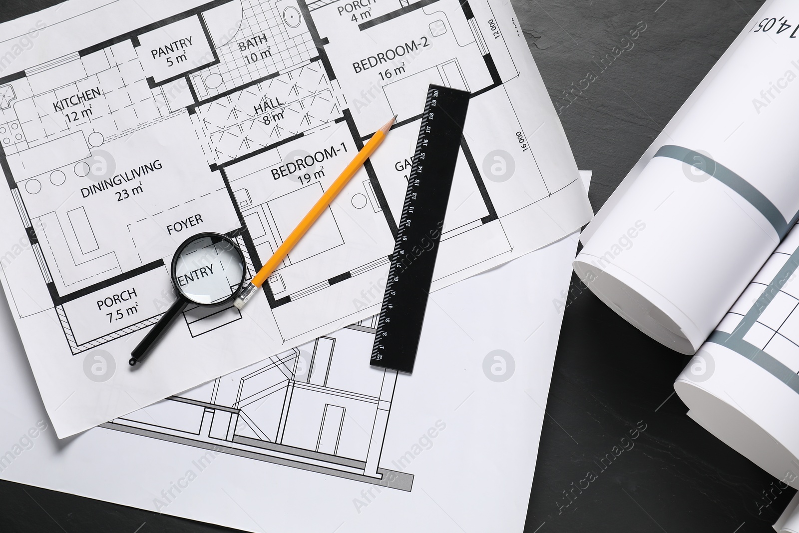 Photo of Different architectural drawings, ruler, pencil and magnifying glass on grey textured table, flat lay