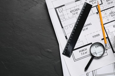 Different architectural drawings, pencil, ruler and magnifying glass on grey textured table, flat lay. Space for text