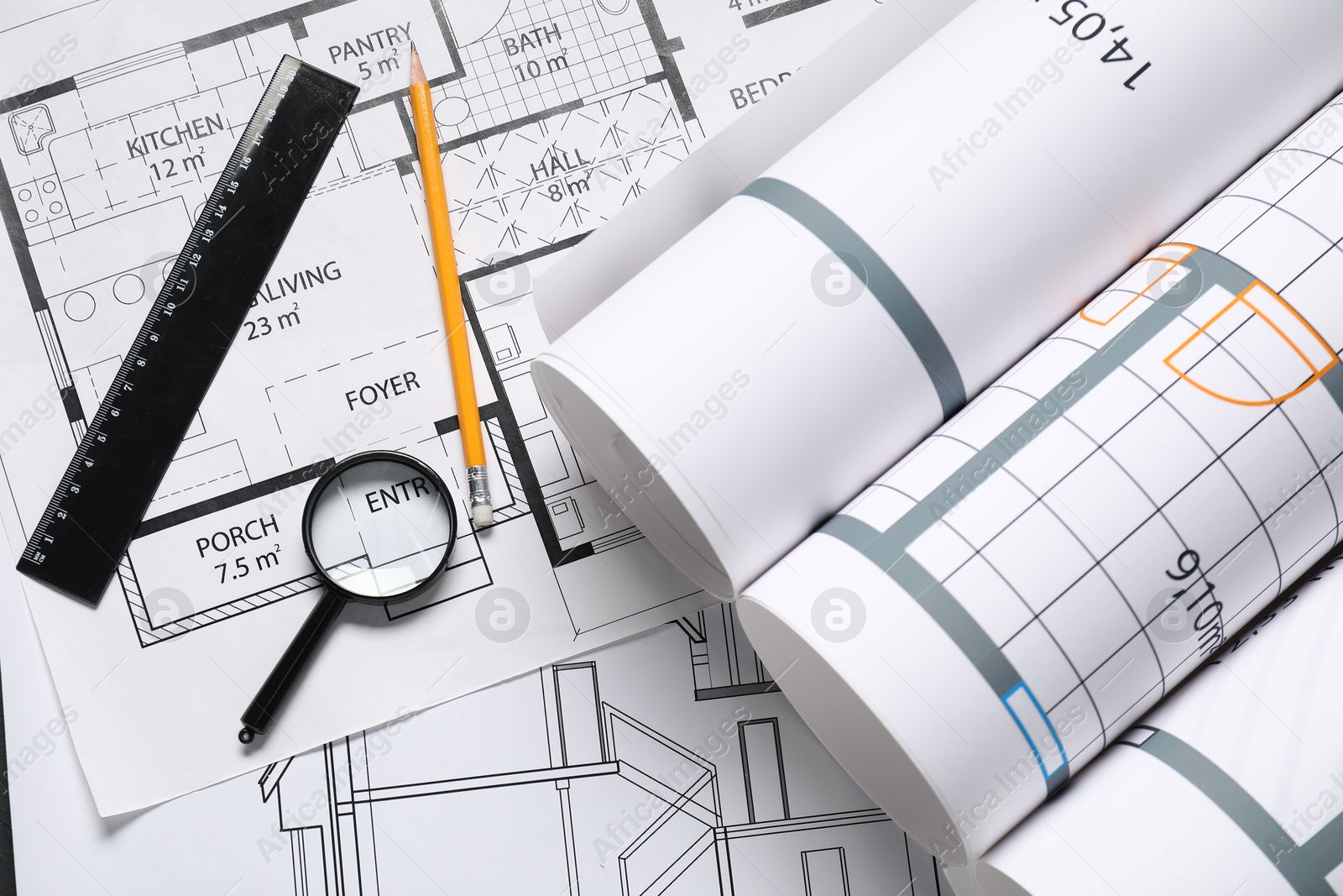 Photo of Different architectural drawings, pencil, ruler and magnifying glass on white table, flat lay