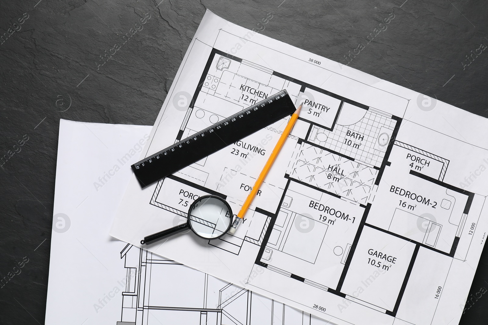 Photo of Different architectural drawings, ruler, pencil and magnifying glass on grey textured table, flat lay