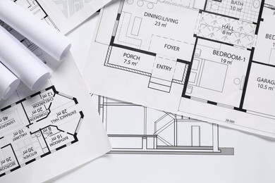 Photo of Different architectural drawings on table, flat lay