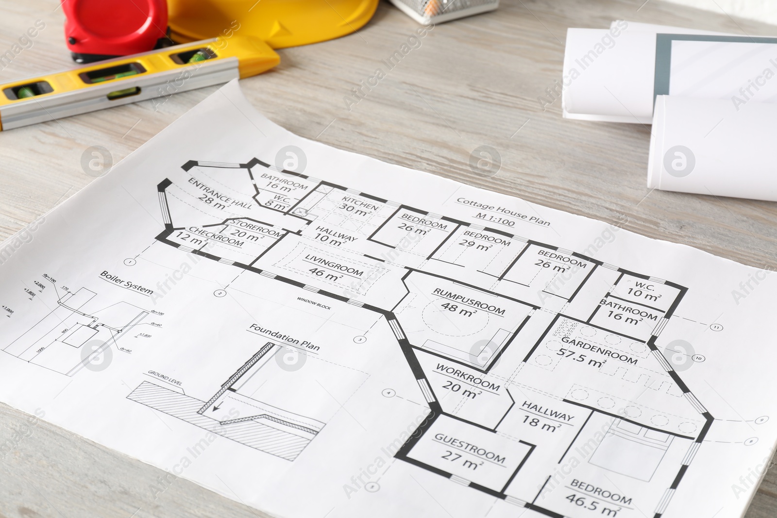 Photo of Different engineering drawings and tools on wooden table