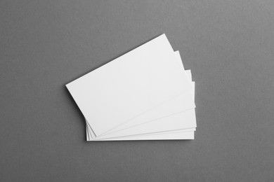 Photo of Blank business cards on grey background, top view. Mockup for design