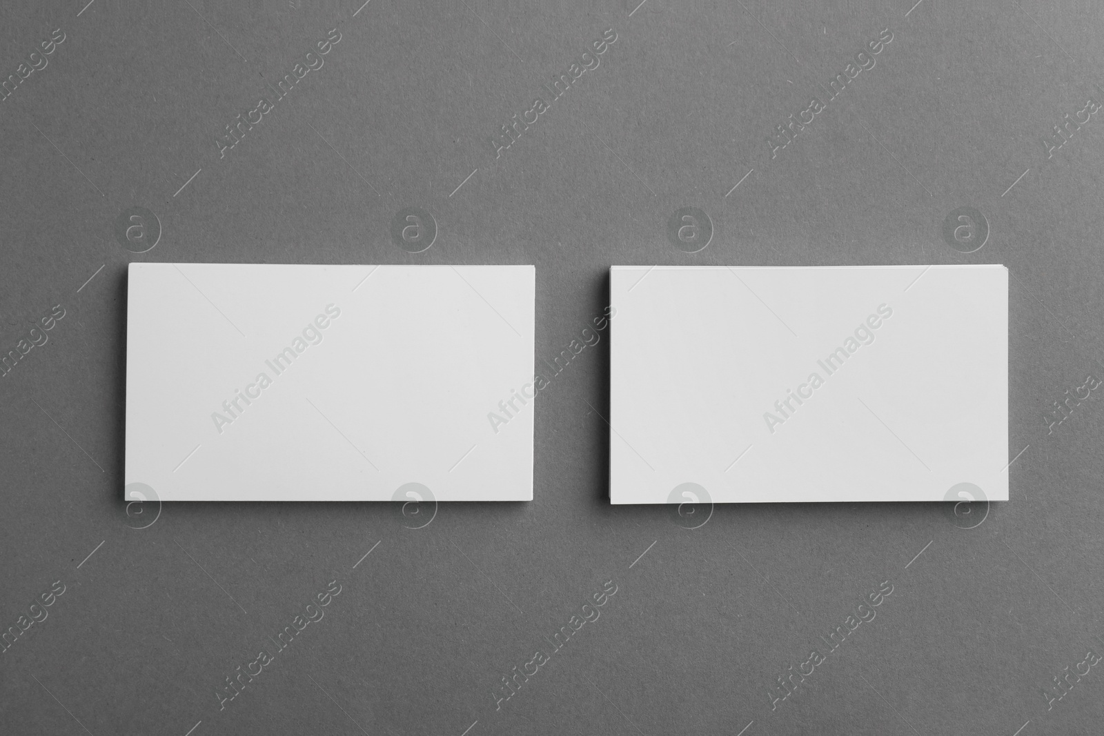 Photo of Blank business cards on grey background, top view. Mockup for design