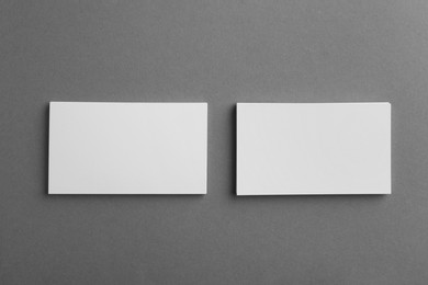 Photo of Blank business cards on grey background, top view. Mockup for design