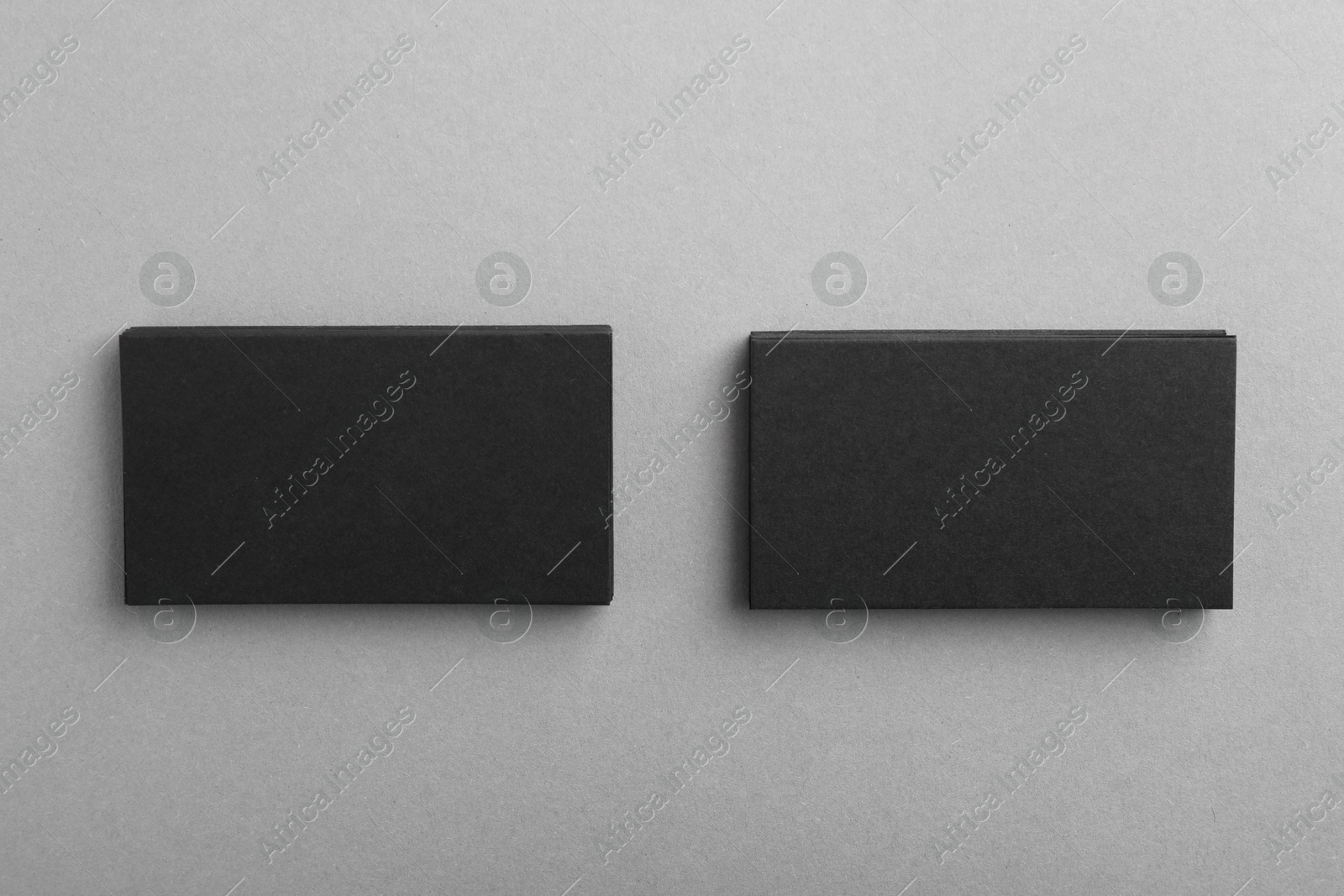 Photo of Blank business cards on grey background, top view. Mockup for design