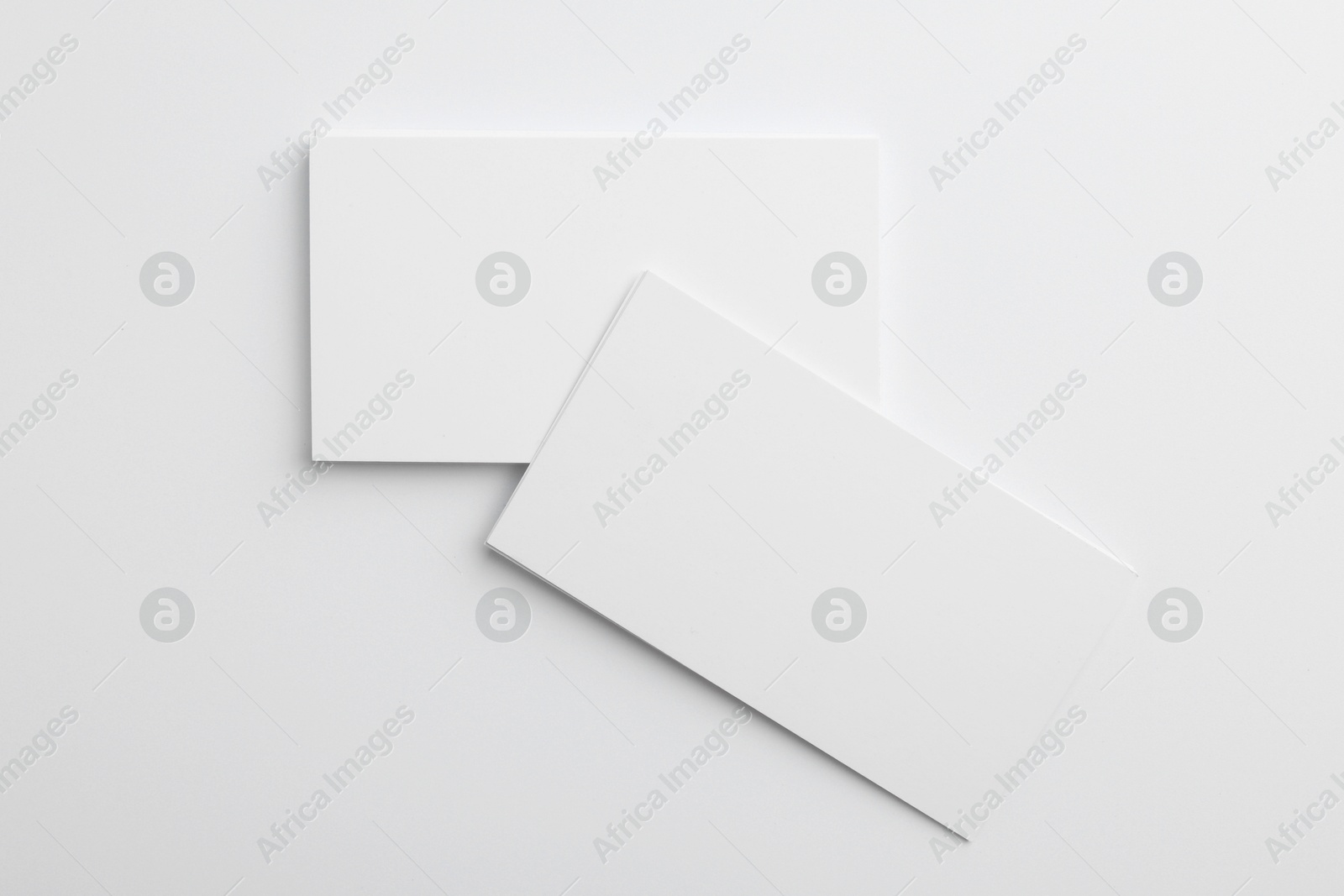 Photo of Blank business cards on light grey background, top view. Mockup for design