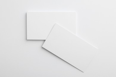 Photo of Blank business cards on light grey background, top view. Mockup for design