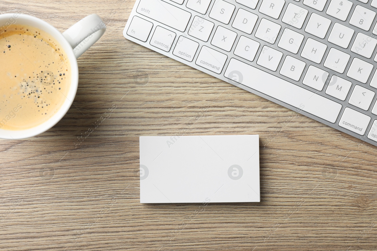 Photo of Blank business cards, coffee and keyboard on wooden table, flat lay. Mockup for design