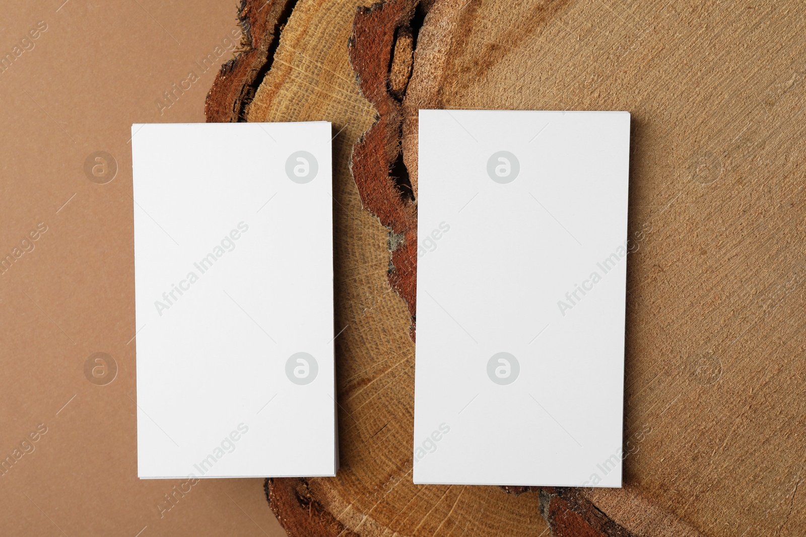 Photo of Blank business cards on brown background, flat lay. Mockup for design