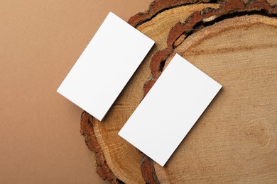 Photo of Blank business cards on brown background, flat lay. Mockup for design