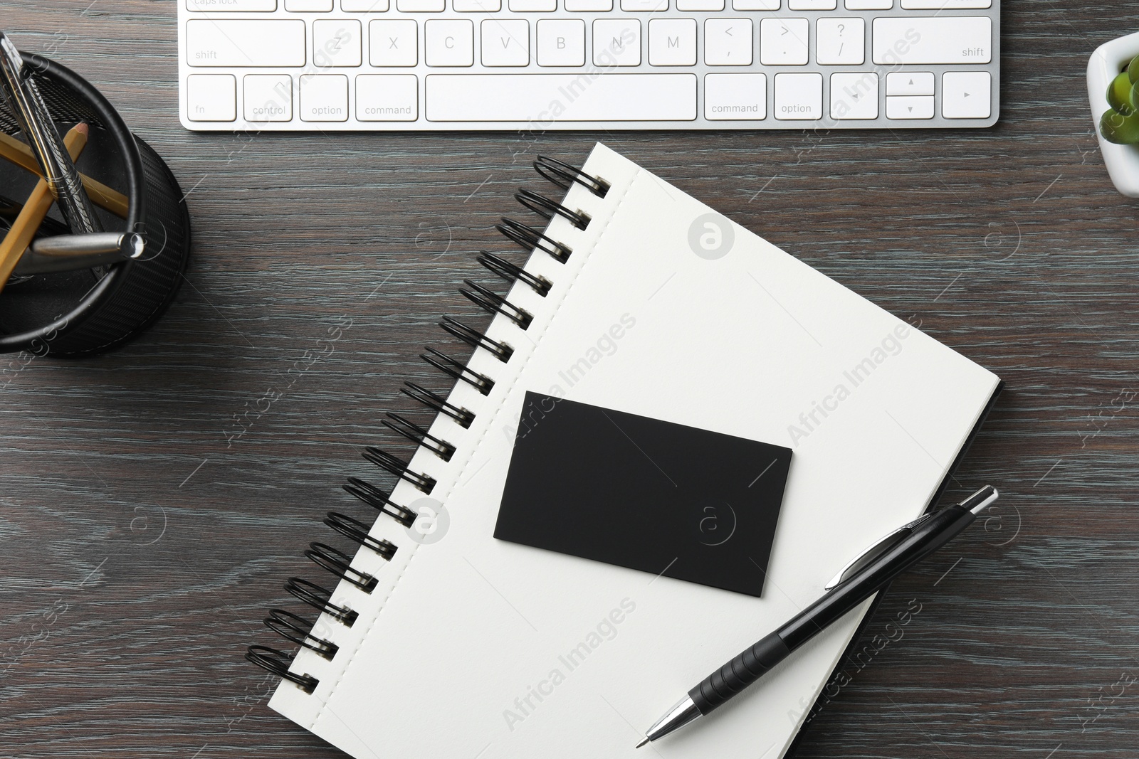 Photo of Blank business cards, keyboard and stationery on wooden table, flat lay. Mockup for design