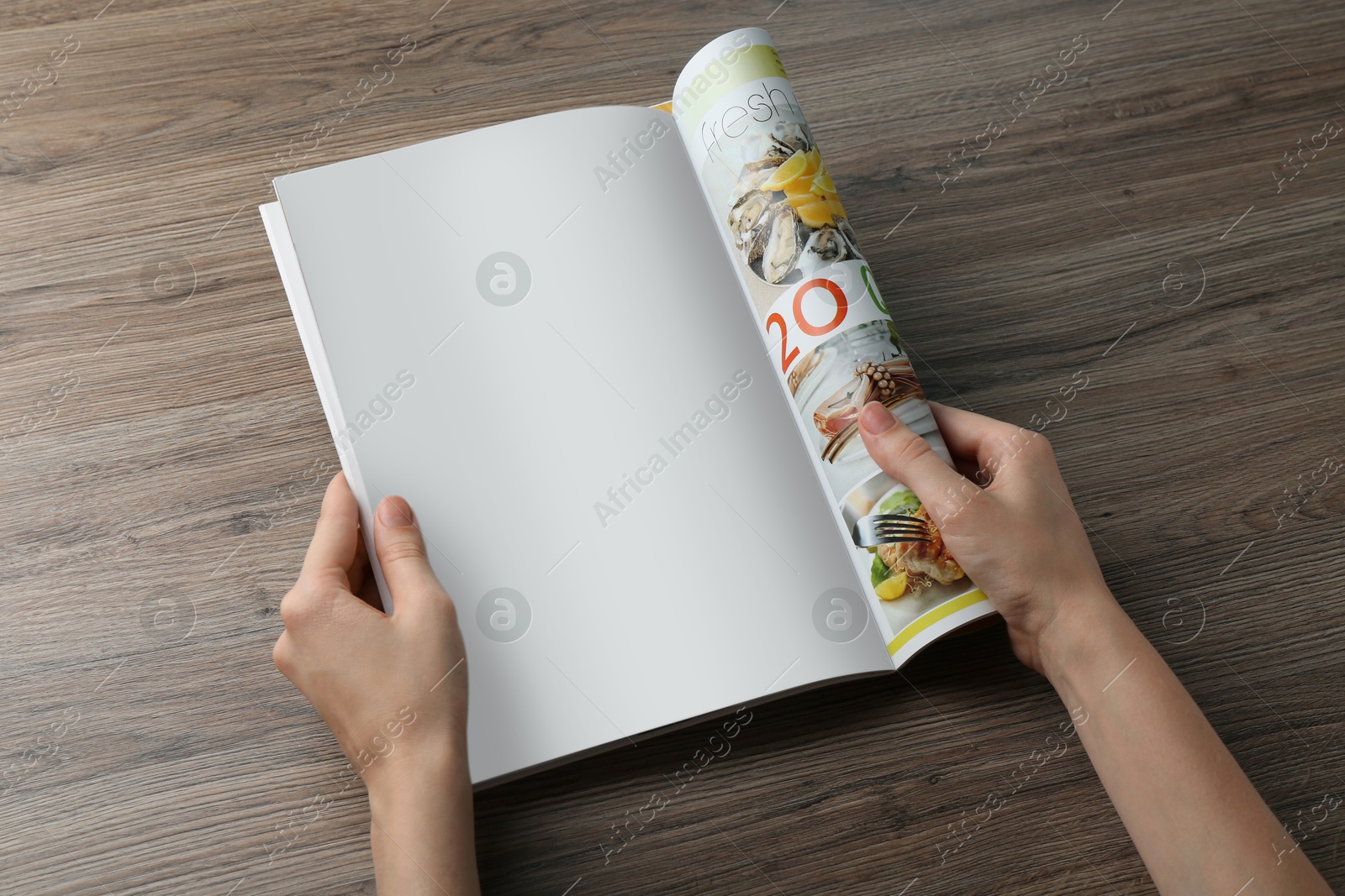 Photo of Woman reading magazine at wooden table, closeup. Mockup for design