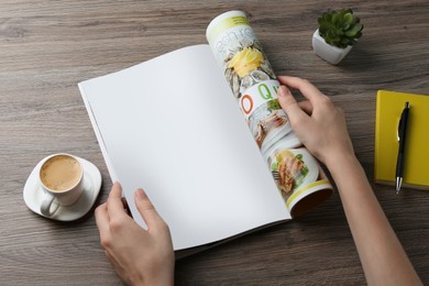 Photo of Woman reading magazine at wooden table, closeup. Mockup for design