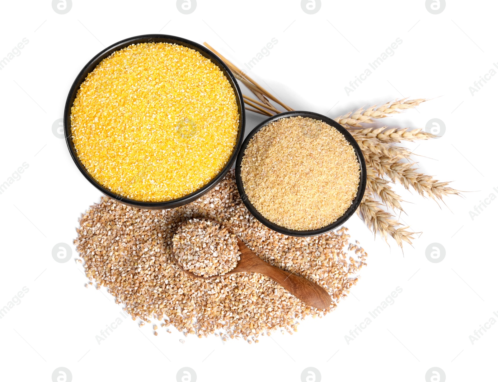 Photo of Different cereals, spoon and spikelets isolated on white, top view